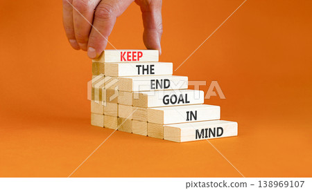 Keep the end goal in mind symbol. Concept words Keep the end goal in mind on beautiful wooden sticks. Beautiful orange paper background. Business keep the end goal in mind concept. Copy space. 138969107