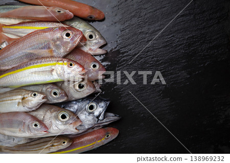 Variety of Raw Fish on Stone Background Top View. Variety of Raw Fish on Stone Background Top View. 138969232