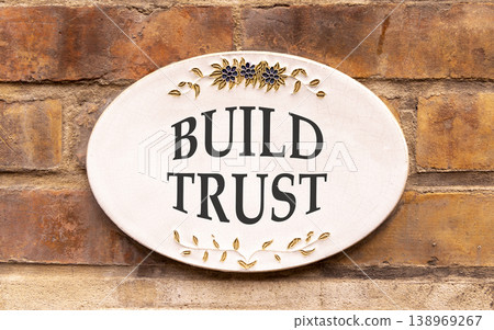 Build trust symbol. Concept words Build trust on beautiful big white sign plate. Beautiful old brown brick wall background. Business and build trust concept, copy space. Build trust symbol. Concept words Build trust on beautiful big white sign plate. Beautiful old brown brick wall background. Business and build trust concept, copy space. 138969267