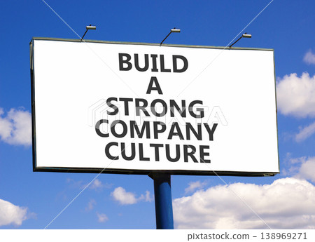 Strong company culture symbol. Concept words Build a strong company culture on beautiful white billboard. Beautiful blue sky background. Business strong company culture concept. Copy space. 138969271