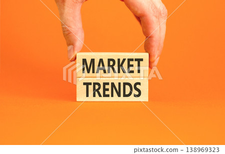 Market trends words symbol. Concept words Market trends on beautiful wooden blocks. Beautiful orange background. Businessman hand. Business and Market trends words concept. Copy space. Market trends words symbol. Concept words Market trends on beautiful wooden blocks. Beautiful orange background. Businessman hand. Business and Market trends words concept. Copy space. 138969323