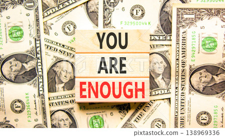 You are enough words symbol. Concept words You are enough on beautiful wooden blocks. Beautiful dollar bills background. Dollar bills. Business motivational and you are enough concept. Copy space. You are enough words symbol. Concept words You are enough on beautiful wooden blocks. Beautiful dollar bills background. Dollar bills. Business motivational and you are enough concept. Copy space. 138969336