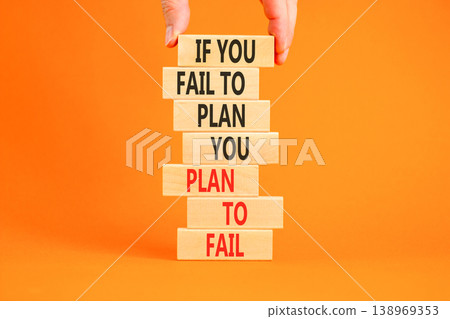 Planning to fail symbol. Concept words If you fail to plan you plan to fail on beautiful wooden blocks. Beautiful orange background. Businessman hand. Business planning to fail concept. Copy space. Planning to fail symbol. Concept words If you fail to plan you plan to fail on beautiful wooden blocks. Beautiful orange background. Businessman hand. Business planning to fail concept. Copy space. 138969353