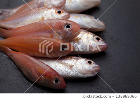Fresh Red Coral Fish on Granite Surface Fresh Red Coral Fish on Granite Surface 138969366