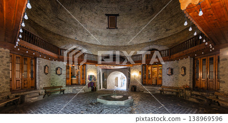 Historic Upper Caravanserai interior with fountain, brick dome, and wooden balcony, Shaki, Azerbaijan Historic Upper Caravanserai interior with fountain, brick dome, and wooden balcony, Shaki, Azerbaijan 138969596