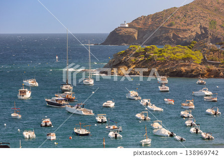 Bay with anchored boats and lighthouse in Cadaques, Catalonia, Spain Bay with anchored boats and lighthouse in Cadaques, Catalonia, Spain 138969742