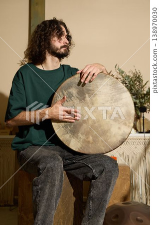 Amateur musician immersed in inviting personal music recording space Amateur musician immersed in inviting personal music recording space 138970030