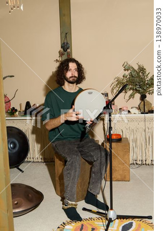 Performer With Drum. Stage Artist With Striking Stance. Musician In Dynamic Pose With Lighting And Props 138970033