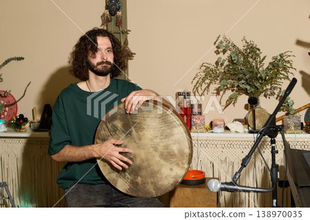 Man conducts drum session in inviting recording studio environment Man conducts drum session in inviting recording studio environment 138970035