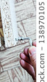 Tightening a screw in furniture assembled from flat parts manually using an Allen key. 138970105