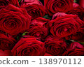 A luxurious bouquet of dark red roses close-up with a velvety texture. 138970112