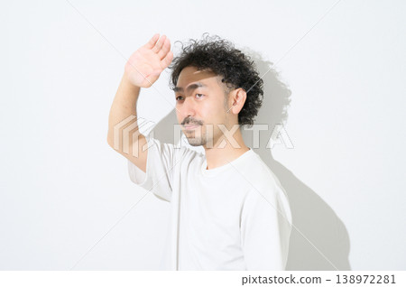 A Japanese man bathed in sunlight against a white background. 138972281