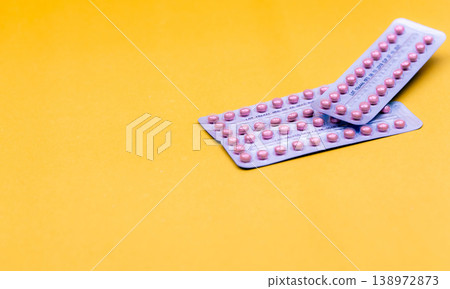 Blister packs of contraceptive pills on yellow background. Hormone pills for treatment hormone acne. Birth control pills. World Contraception Day. Pharmacy banner. Prescription drugs. Hormone pills. Blister packs of contraceptive pills on yellow background. Hormone pills for treatment hormone acne. Birth control pills. World Contraception Day. Pharmacy banner. Prescription drugs. Hormone pills. 138972873