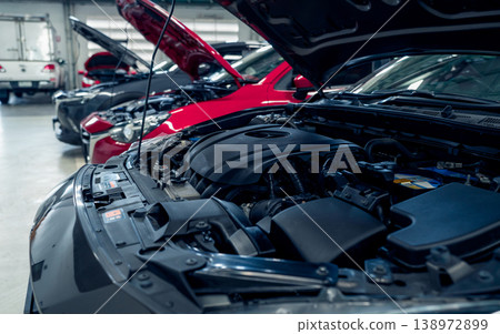 Auto repair shop. Cars open bonnet parked in garage for repair and maintenance service. Car check up at service station. Car waiting for inspection in auto repair shop. Car maintenance and checklist. 138972899