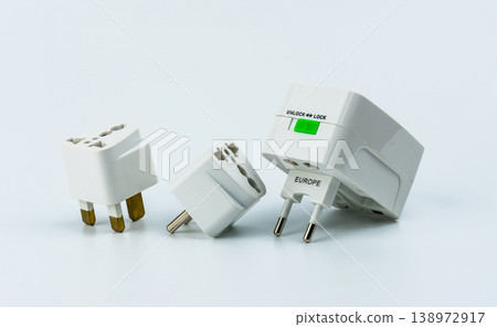 Set of universal travel plug adapters, compact kit for international electricity compatibility. Power socket types for global tourism, portable accessory for safe device charging. Travel accessory. Set of universal travel plug adapters, compact kit for international electricity compatibility. Power socket types for global tourism, portable accessory for safe device charging. Travel accessory. 138972917