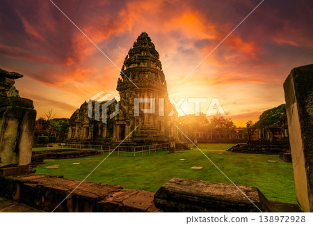 Selective focus on Phimai Historical Park with sunset sky. Landmark of Nakhon Ratchasima, Thailand. Travel destinations. Historic site is ancient. Ancient building. Khmer temple classical architecture Selective focus on Phimai Historical Park with sunset sky. Landmark of Nakhon Ratchasima, Thailand. Travel destinations. Historic site is ancient. Ancient building. Khmer temple classical architecture 138972928