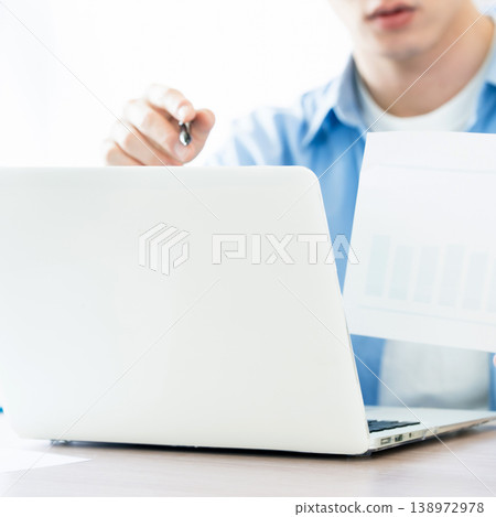 A young man thinking while looking at documents. 138972978