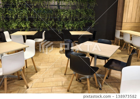 canteen tables and chairs by ivy climber plants on wall canteen tables and chairs by ivy climber plants on wall 138973582