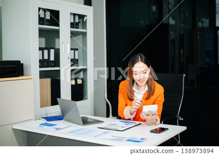 Portrait of a young women sitting at his desk in the office. Portrait of a young women sitting at his desk in the office. 138973894