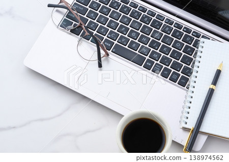 Image of a man drinking coffee and working on a laptop Image of a man drinking coffee and working on a laptop 138974562