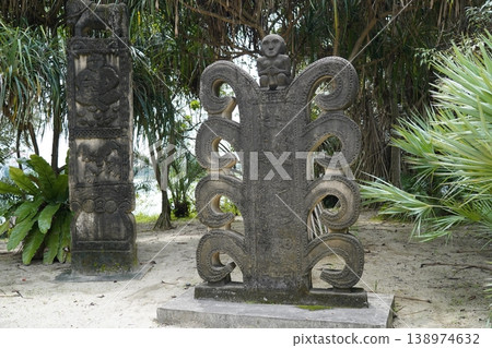 Ancient Stone Carvings in a Tropical Garden Ancient Stone Carvings in a Tropical Garden 138974632