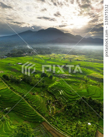 Beautiful morning view in Indonesia, panoramic landscape of rice fields with mountain ranges and clear sky Beautiful morning view in Indonesia, panoramic landscape of rice fields with mountain ranges and clear sky 138975532