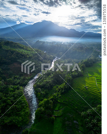 Beautiful morning view in Indonesia, panoramic landscape of rice fields with mountain ranges and clear sky Beautiful morning view in Indonesia, panoramic landscape of rice fields with mountain ranges and clear sky 138975558