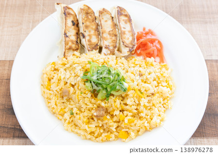 Delicious pan-fried dumplings and fried rice plate with pickled ginger Delicious pan-fried dumplings and fried rice plate with pickled ginger 138976278