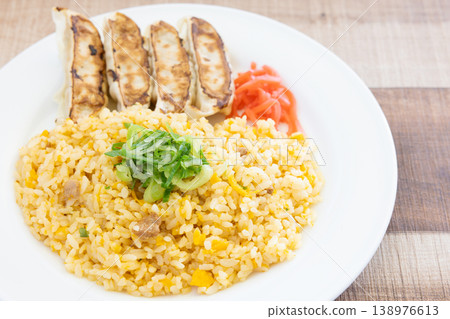 Delicious pan-fried dumplings and fried rice plate with pickled ginger Delicious pan-fried dumplings and fried rice plate with pickled ginger 138976613
