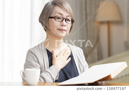 Senior woman reading in the living room Senior woman reading in the living room 138977197