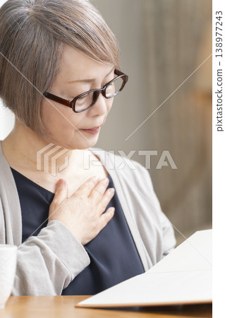 Senior woman reading in the living room Senior woman reading in the living room 138977243