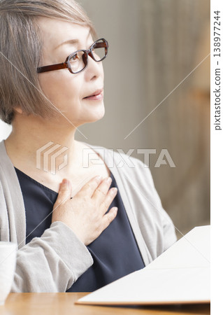 Senior woman reading in the living room Senior woman reading in the living room 138977244