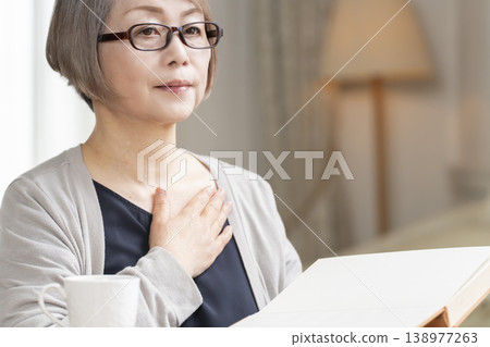 Senior woman reading in the living room Senior woman reading in the living room 138977263