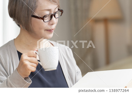 Senior woman reading in the living room Senior woman reading in the living room 138977264