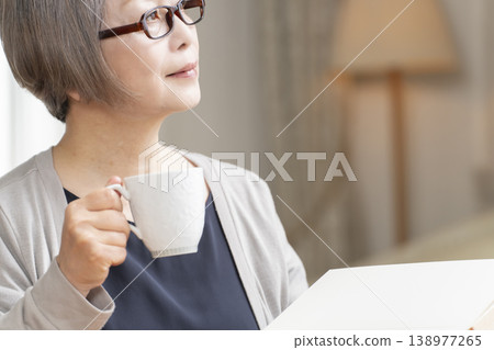 Senior woman reading in the living room 138977265