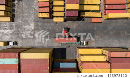 Aerial view reach stacker work with semi trailer, Global business logistic transportation container cargo international, Container cargo industrial import export reach stacker and semi truck trailer. 138978110