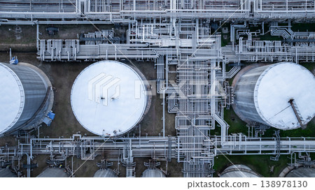 Aerial view white oil storage tank with pipeline steel, Crude oil industry, Storage fuel gas container tank petroleum refinery industrial factory, Oil storage chemical petrochemical refinery product. Aerial view white oil storage tank with pipeline steel, Crude oil industry, Storage fuel gas container tank petroleum refinery industrial factory, Oil storage chemical petrochemical refinery product. 138978130