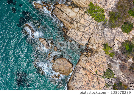 Aerial view of Rose Bay in Bowen, Queensland, Australia. The scene shows a tropical coastal landscape with clear blue water, sandy shoreline and surrounding natural environment. Aerial view of Rose Bay in Bowen, Queensland, Australia. The scene shows a tropical coastal landscape with clear blue water, sandy shoreline and surrounding natural environment. 138978289