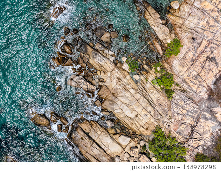 Aerial view of Rose Bay in Bowen, Queensland, Australia. The scene shows a tropical coastal landscape with clear blue water, sandy shoreline and surrounding natural environment. Aerial view of Rose Bay in Bowen, Queensland, Australia. The scene shows a tropical coastal landscape with clear blue water, sandy shoreline and surrounding natural environment. 138978298