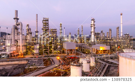Aerial view oil and gas industrial refinery at twilight, Oil refinery and Petrochemical plant pipeline steel, Refinery factory oil storage tank and pipeline steel at night. 138978325