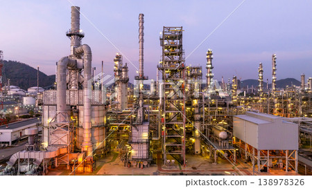 Aerial view oil and gas industrial refinery at twilight, Oil refinery and Petrochemical plant pipeline steel, Refinery factory oil storage tank and pipeline steel at night. 138978326