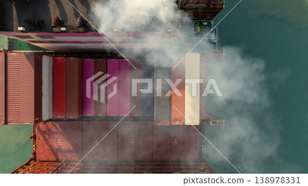 Aerial view container cargo ship with smoke exhaust gas emissions, Container cargo ship diesel engine exhaust gas combustion, Smoke exhaust gas emissions carbondioxide container cargo ship. Aerial view container cargo ship with smoke exhaust gas emissions, Container cargo ship diesel engine exhaust gas combustion, Smoke exhaust gas emissions carbondioxide container cargo ship. 138978331