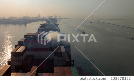 Aerial view container cargo ship with smoke exhaust gas emissions, Container cargo ship diesel engine exhaust gas combustion, Smoke exhaust gas emissions carbondioxide container cargo  ship. 138978332
