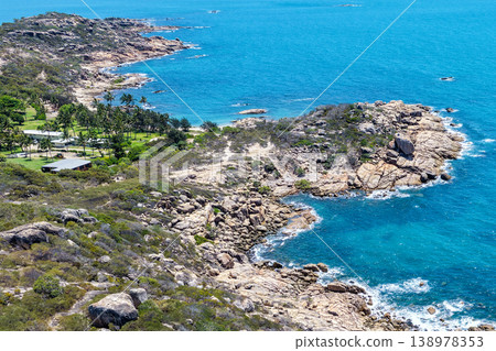 Aerial view of Rose Bay in Bowen, Queensland, Australia. The scene shows a tropical coastal landscape with clear blue water, sandy shoreline and surrounding natural environment. 138978353