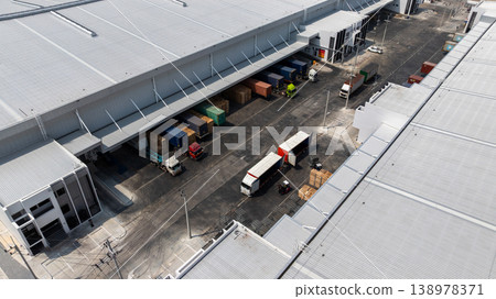 Aerial view modern warehouse for trucks unloading and loading, semi truck cargo trailer at logistic park warehouse, Distribution warehouse shipping supply chain, Business transportation logistic. Aerial view modern warehouse for trucks unloading and loading, semi truck cargo trailer at logistic park warehouse, Distribution warehouse shipping supply chain, Business transportation logistic. 138978371