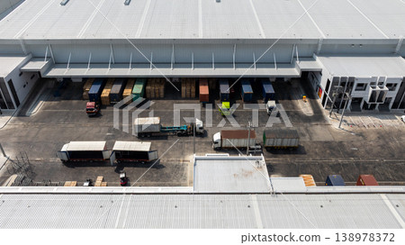 Aerial view modern warehouse for trucks unloading and loading, semi truck cargo trailer at logistic park warehouse, Distribution warehouse shipping supply chain, Business transportation logistic. Aerial view modern warehouse for trucks unloading and loading, semi truck cargo trailer at logistic park warehouse, Distribution warehouse shipping supply chain, Business transportation logistic. 138978372