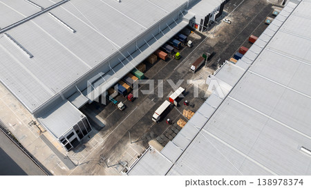 Aerial view modern warehouse for trucks unloading and loading, semi truck cargo trailer at logistic park warehouse, Distribution warehouse shipping supply chain, Business transportation logistic. Aerial view modern warehouse for trucks unloading and loading, semi truck cargo trailer at logistic park warehouse, Distribution warehouse shipping supply chain, Business transportation logistic. 138978374
