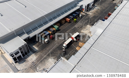 Aerial view modern warehouse for trucks unloading and loading, semi truck cargo trailer at logistic park warehouse, Distribution warehouse shipping supply chain, Business transportation logistic. 138978488