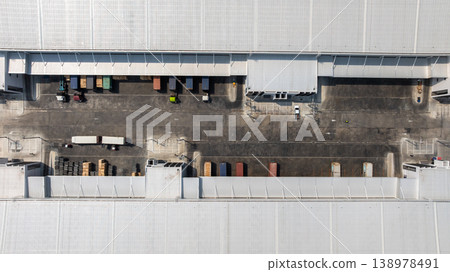 Aerial view modern warehouse for trucks unloading and loading, semi truck cargo trailer at logistic park warehouse, Distribution warehouse shipping supply chain, Business transportation logistic. Aerial view modern warehouse for trucks unloading and loading, semi truck cargo trailer at logistic park warehouse, Distribution warehouse shipping supply chain, Business transportation logistic. 138978491