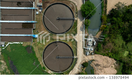 Aerial view wastewater treatment plant. Circular sedimentation tanks biological reactor, Water cleaning facility wastewater treatment plant, Recirculation solid contact clarifier sedimentation tank. Aerial view wastewater treatment plant. Circular sedimentation tanks biological reactor, Water cleaning facility wastewater treatment plant, Recirculation solid contact clarifier sedimentation tank. 138978494
